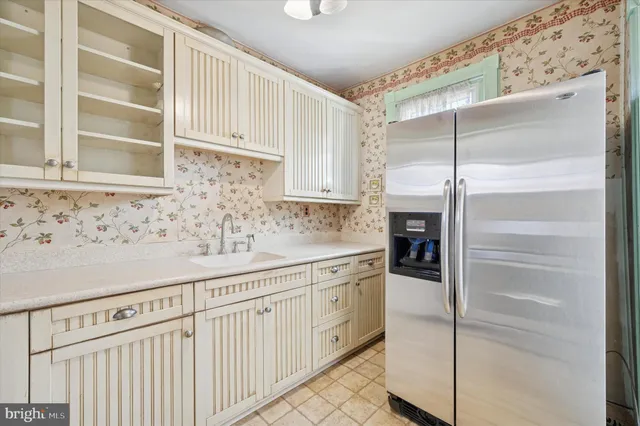 a kitchen with white cabinets and white appliances