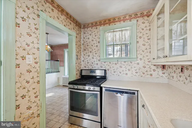 a kitchen with granite countertop a sink stove and cabinets