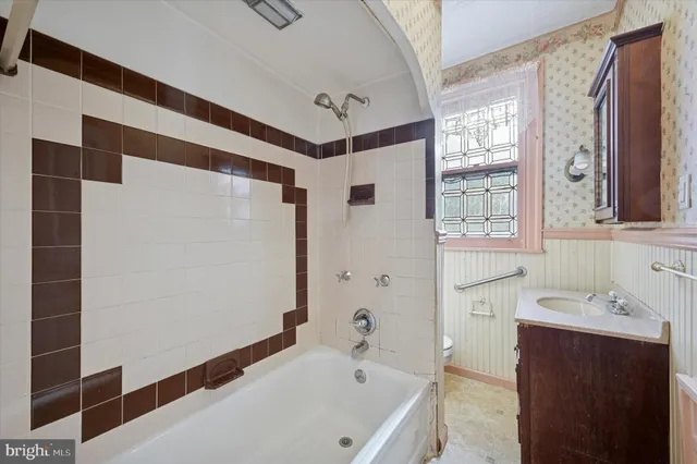 a bathroom with a bathtub and a sink