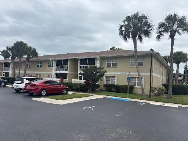 a front view of a house with a garden and plants