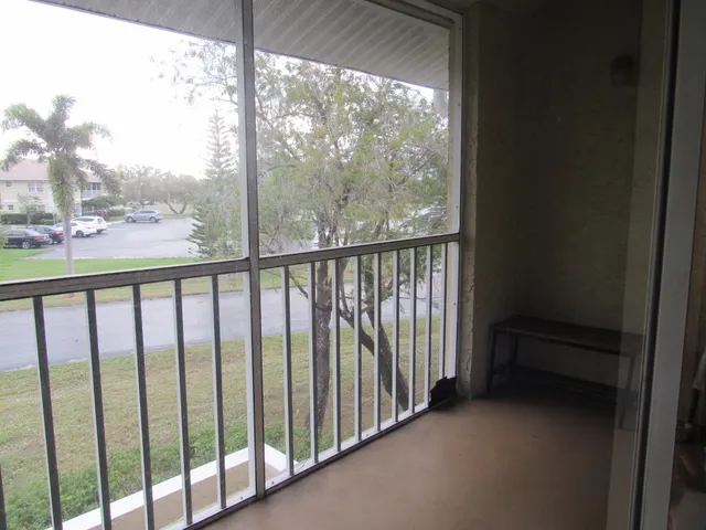 a view of a balcony with wooden floor