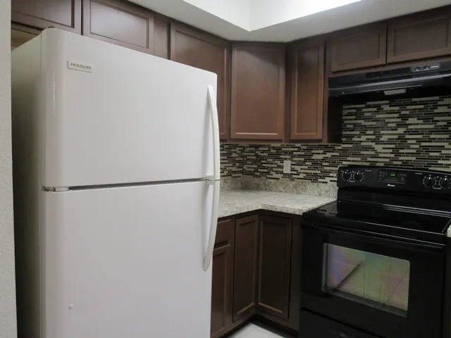 a white refrigerator freezer sitting in a kitchen