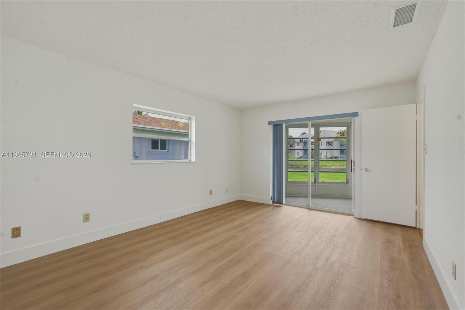 9306 Northwest 80th Street Tamarac, FL 33321 - Photo 13 of 45 a view of a room with an empty room and wooden floor