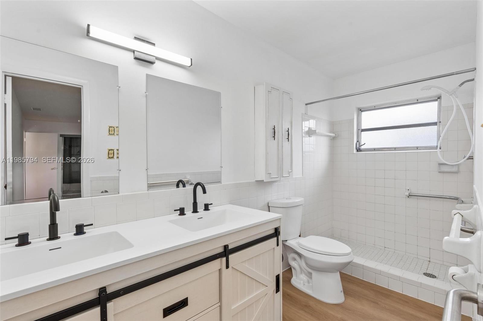 9306 Northwest 80th Street Tamarac, FL 33321 - Photo 14 of 45 a bathroom with a sink a toilet and a mirror