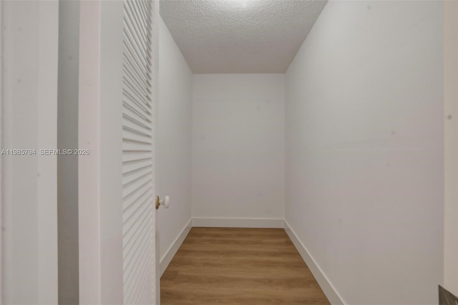 9306 Northwest 80th Street Tamarac, FL 33321 - Photo 16 of 45 a view of a hallway with wooden floor and staircase