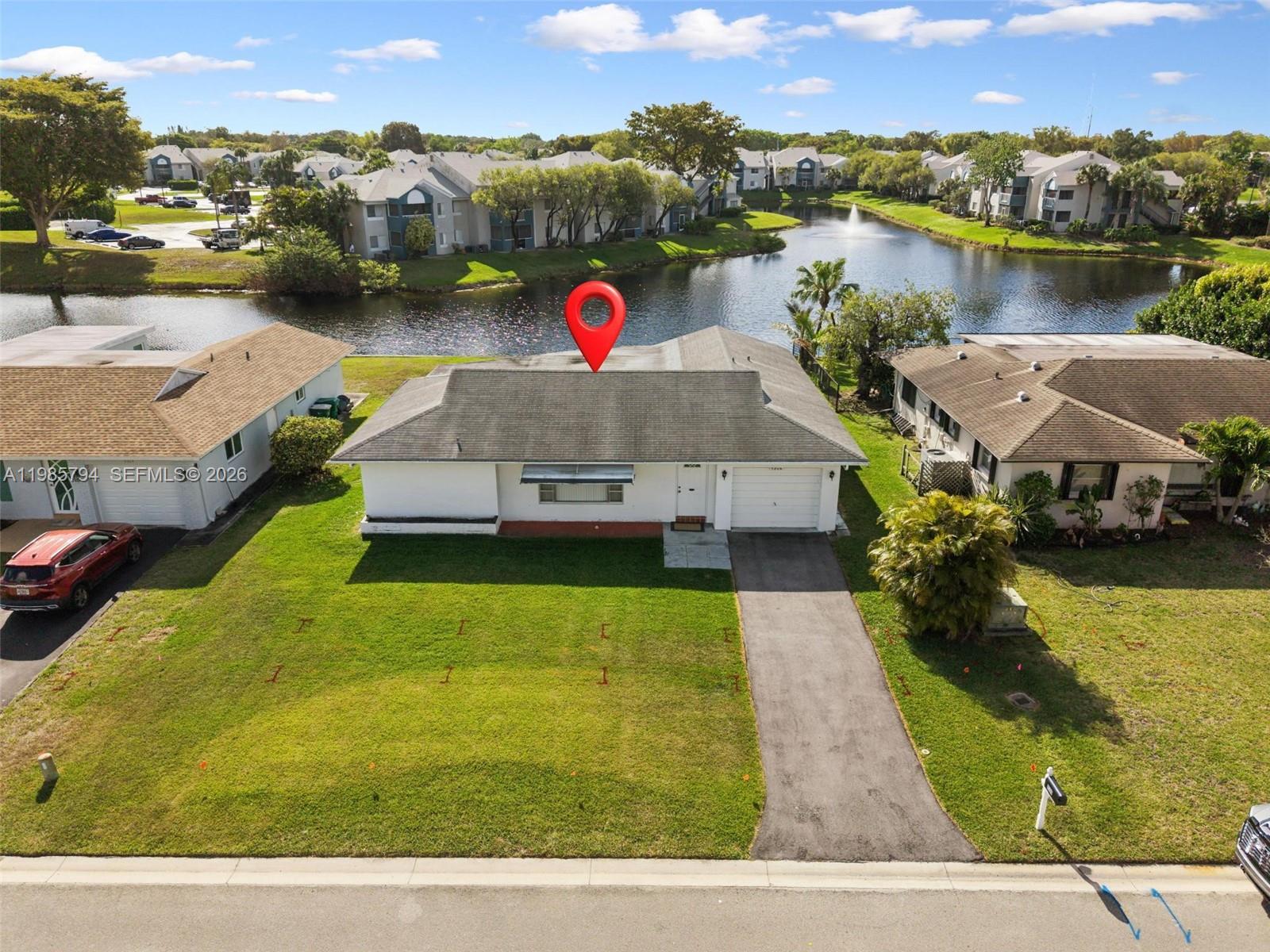 9306 Northwest 80th Street Tamarac, FL 33321 - Photo 2 of 45 a view of a lake with a house