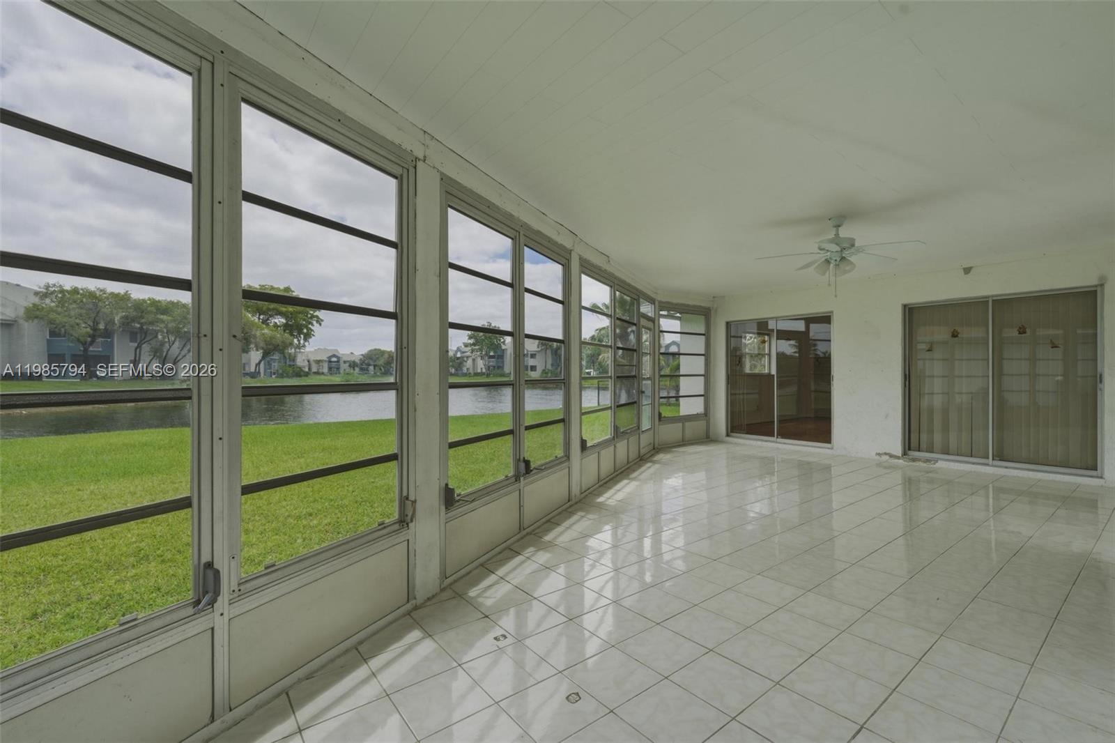 9306 Northwest 80th Street Tamarac, FL 33321 - Photo 22 of 45 a view of an empty room with sliding glass door and windows
