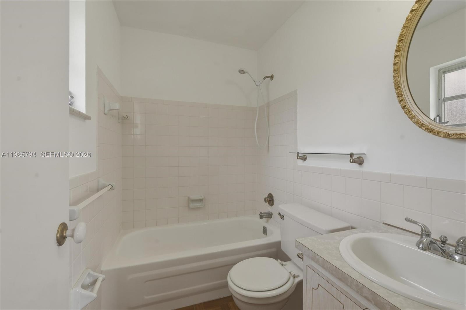 9306 Northwest 80th Street Tamarac, FL 33321 - Photo 23 of 45 a bathroom with a toilet a sink and bathtub