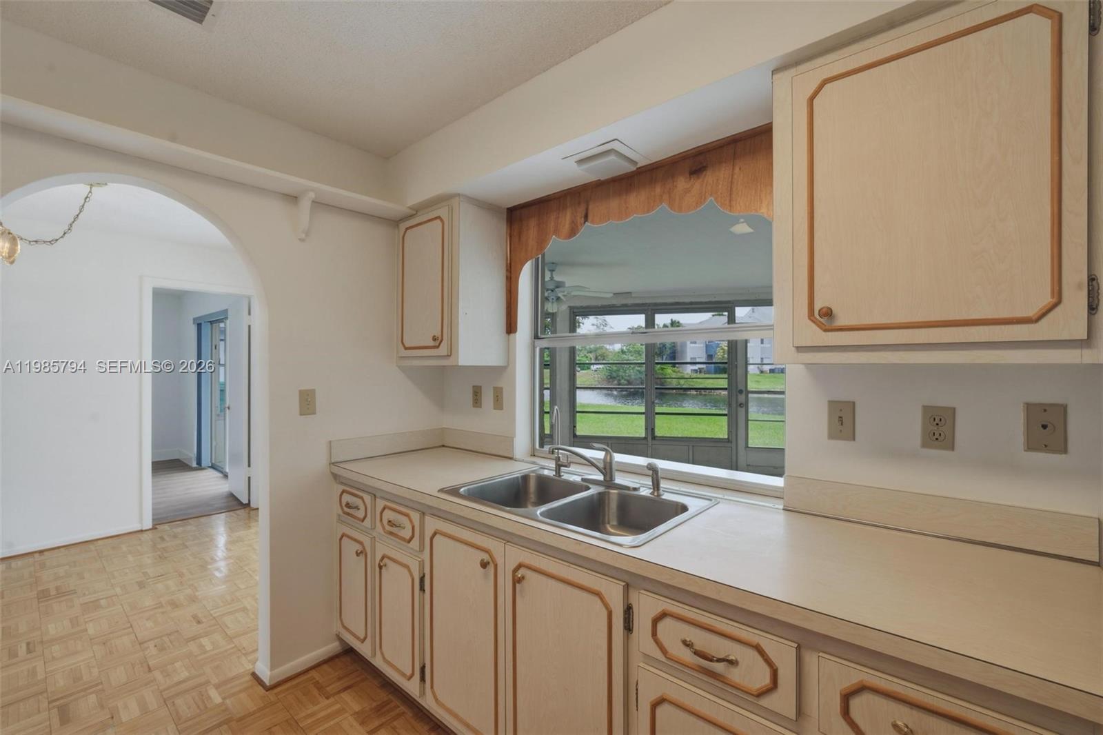 9306 Northwest 80th Street Tamarac, FL 33321 - Photo 26 of 45 a kitchen with stainless steel appliances granite countertop a sink and a white cabinets