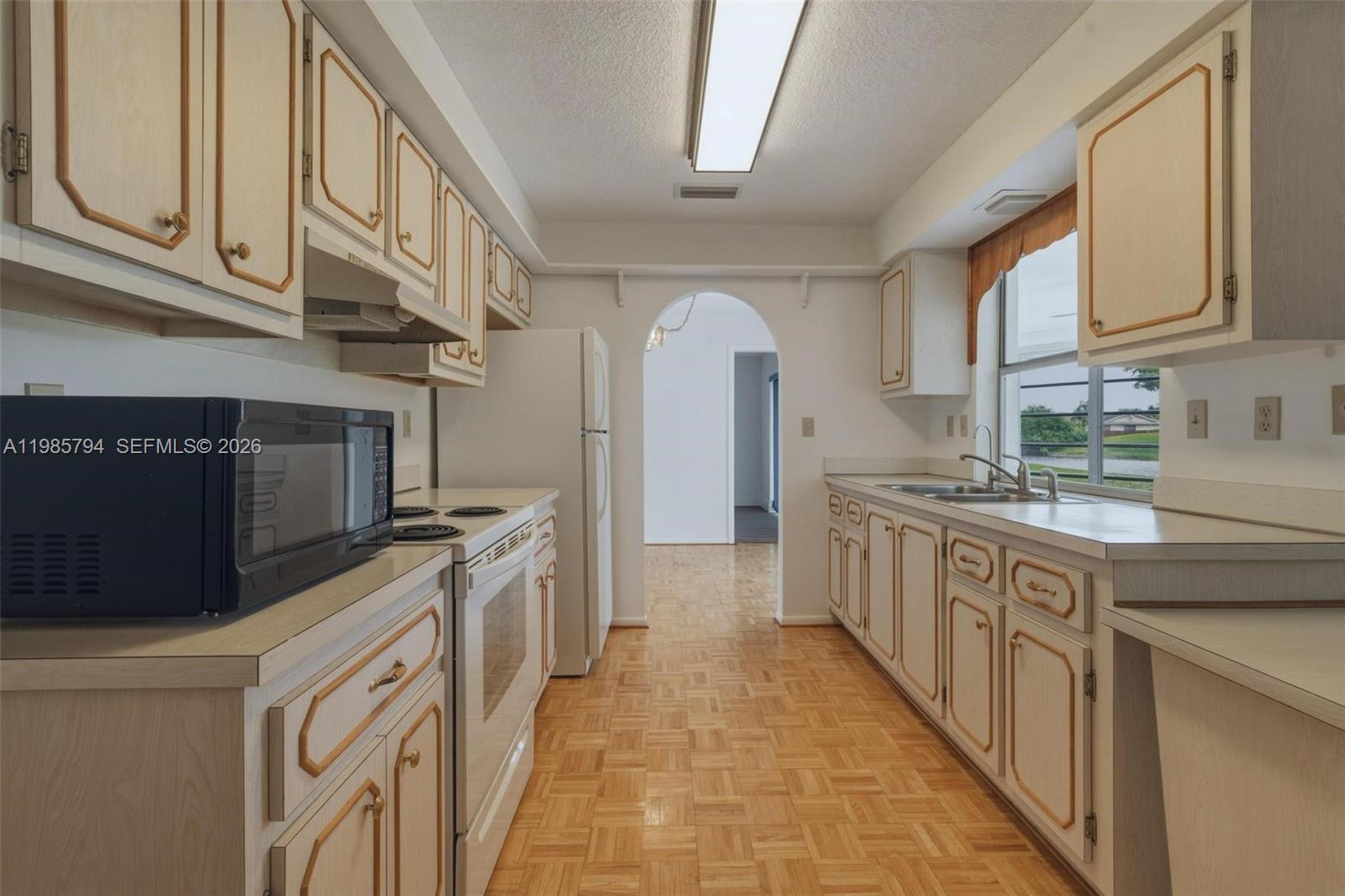 9306 Northwest 80th Street Tamarac, FL 33321 - Photo 27 of 45 a kitchen with stainless steel appliances granite countertop a stove and a sink