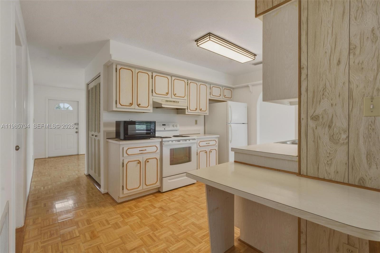 9306 Northwest 80th Street Tamarac, FL 33321 - Photo 28 of 45 a kitchen with white cabinets and white appliances