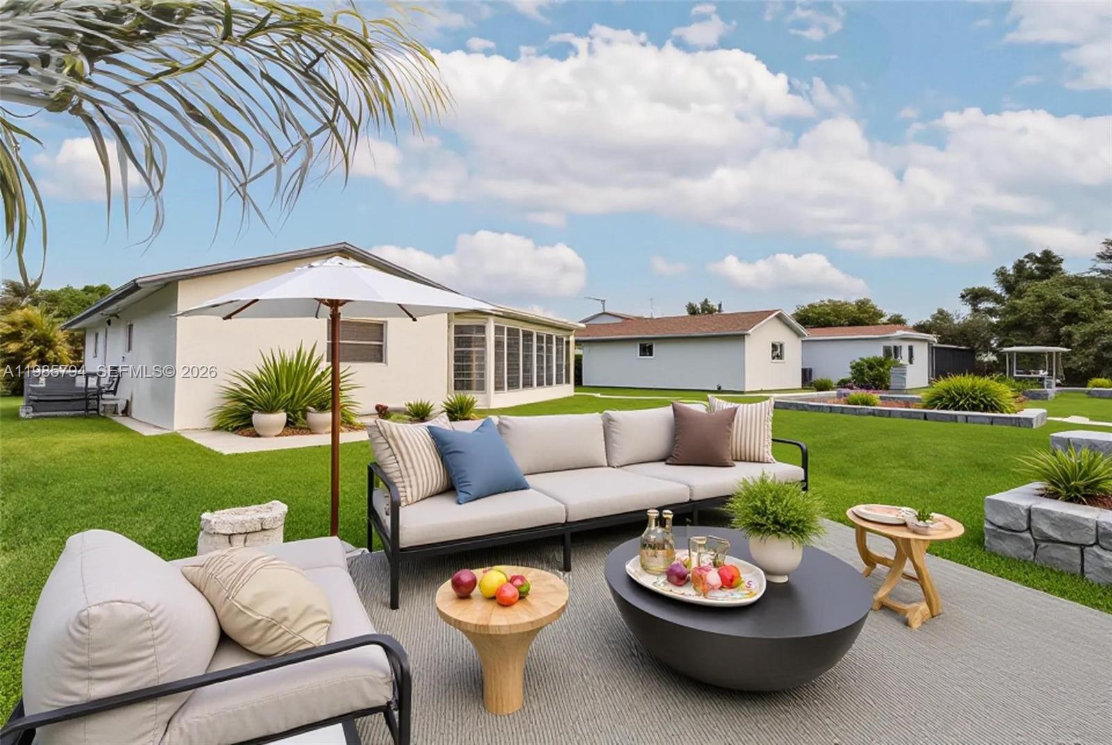 9306 Northwest 80th Street Tamarac, FL 33321 - Photo 33 of 45 a view of a patio with couches chairs and a yard