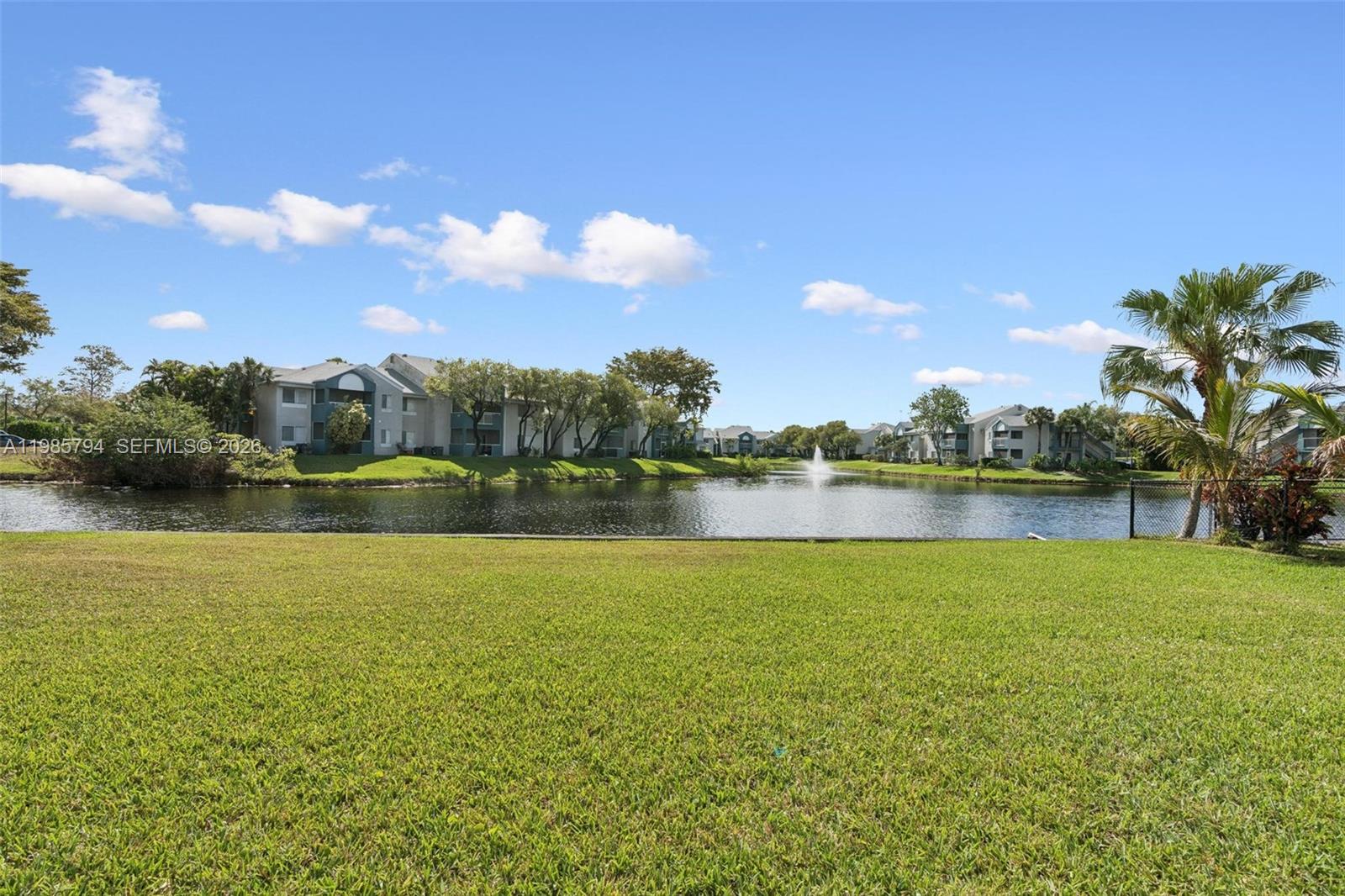 9306 Northwest 80th Street Tamarac, FL 33321 - Photo 36 of 45 a view of a lake with houses in the back