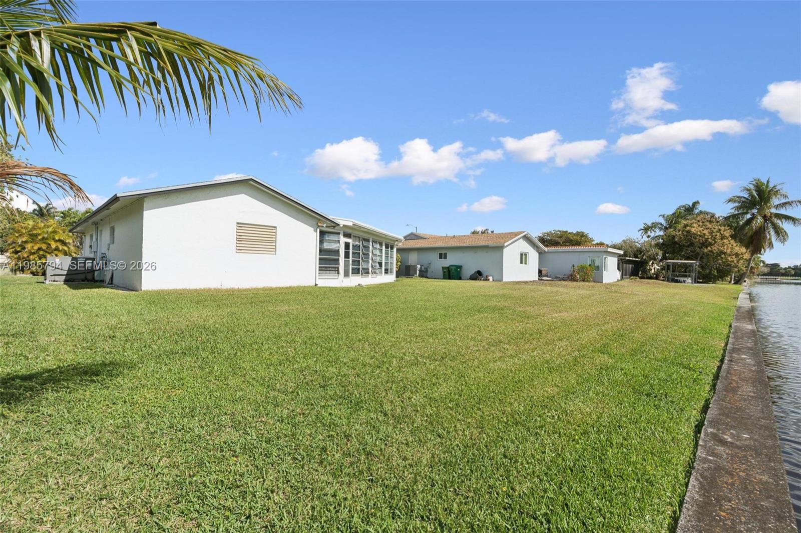 9306 Northwest 80th Street Tamarac, FL 33321 - Photo 41 of 45 a view of a house with a yard