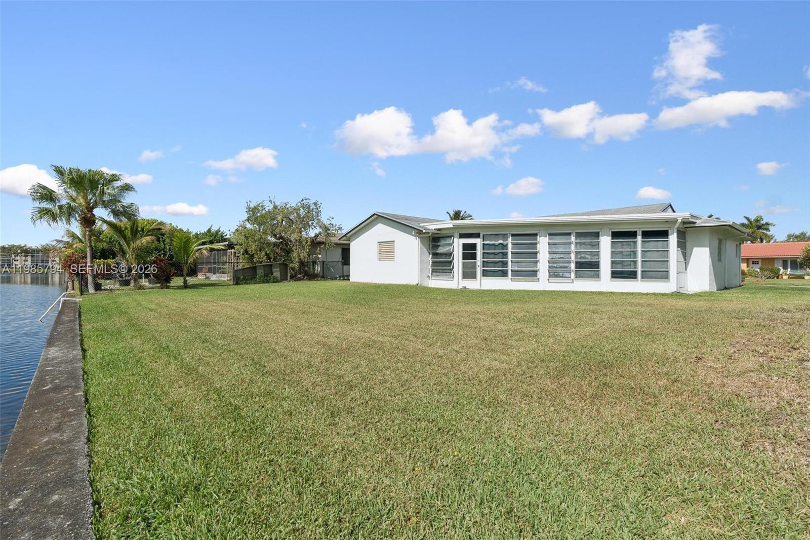 9306 Northwest 80th Street Tamarac, FL 33321 - Photo 43 of 45 a view of a house with a garden and yard