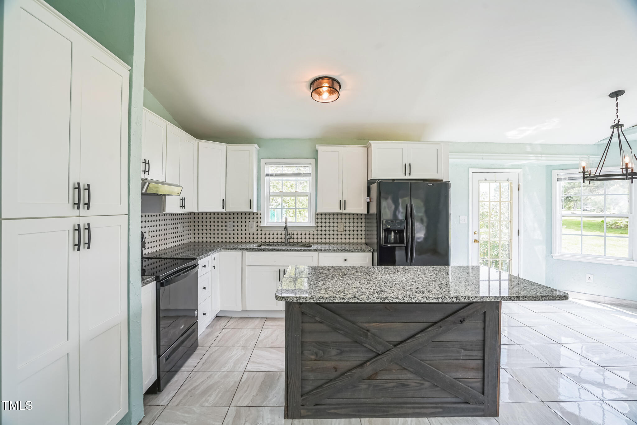 1270 Old School Road Four Oaks, NC 27524 - Photo 13 of 30 a large kitchen with granite countertop a stove refrigerator and cabinets