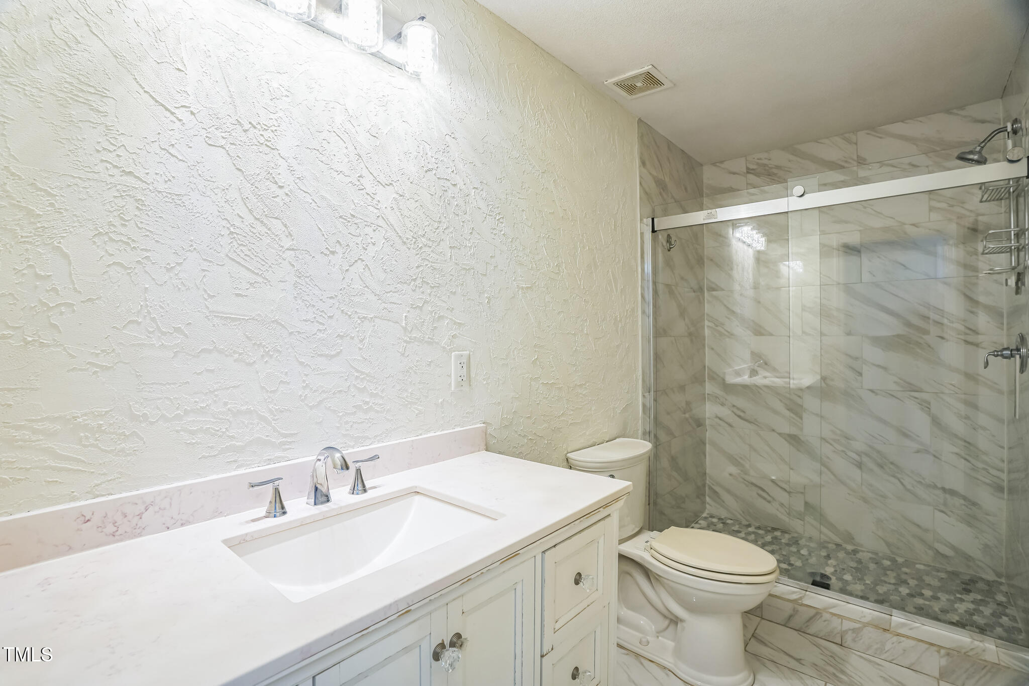 1270 Old School Road Four Oaks, NC 27524 - Photo 17 of 30 a bathroom with a granite countertop sink toilet and shower