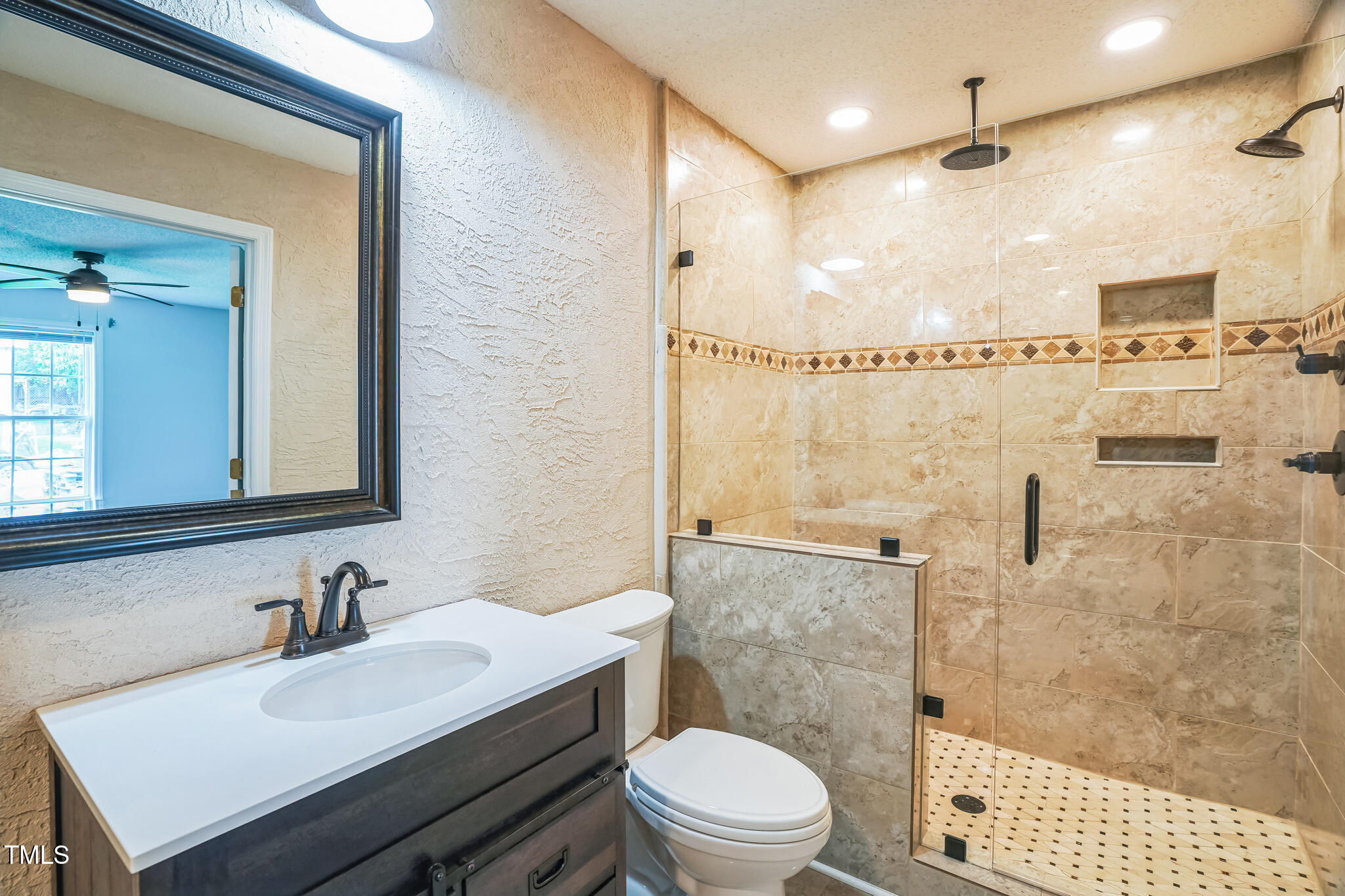 1270 Old School Road Four Oaks, NC 27524 - Photo 19 of 30 a bathroom with a sink a toilet and shower