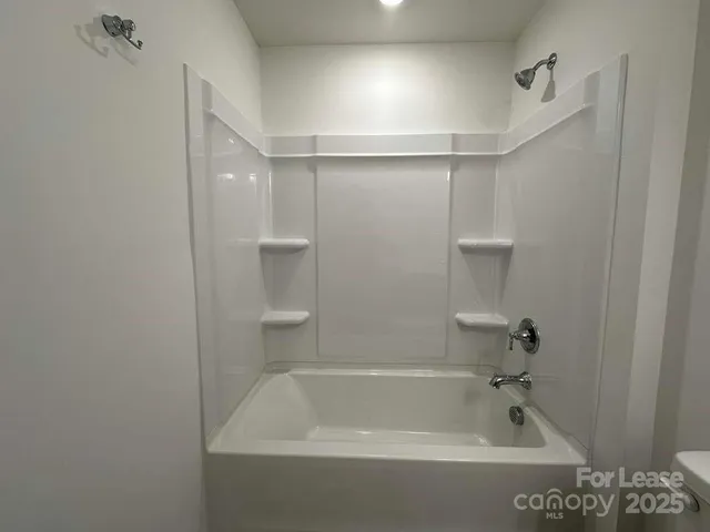 a bathroom with a shower and tub