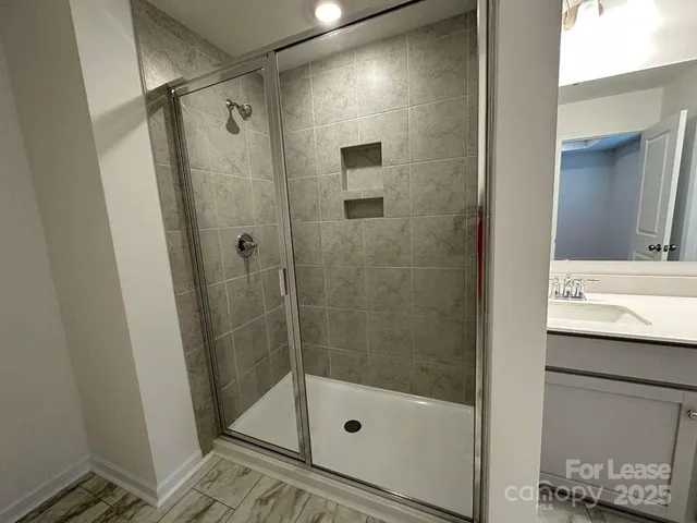 a bathroom with a shower and a sink