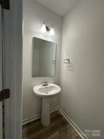 a bathroom with a sink toilet and mirror