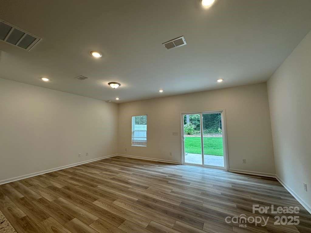 3514 Nimbell Road Monroe, NC 28110 - Photo 2 of 19 an empty room with wooden floor and windows
