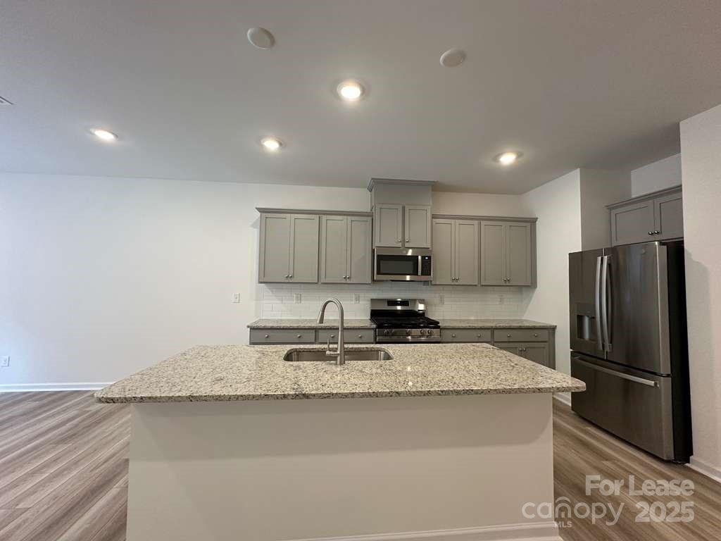 3514 Nimbell Road Monroe, NC 28110 - Photo 6 of 19 a kitchen with stainless steel appliances granite countertop a refrigerator a sink a stove a microwave and island