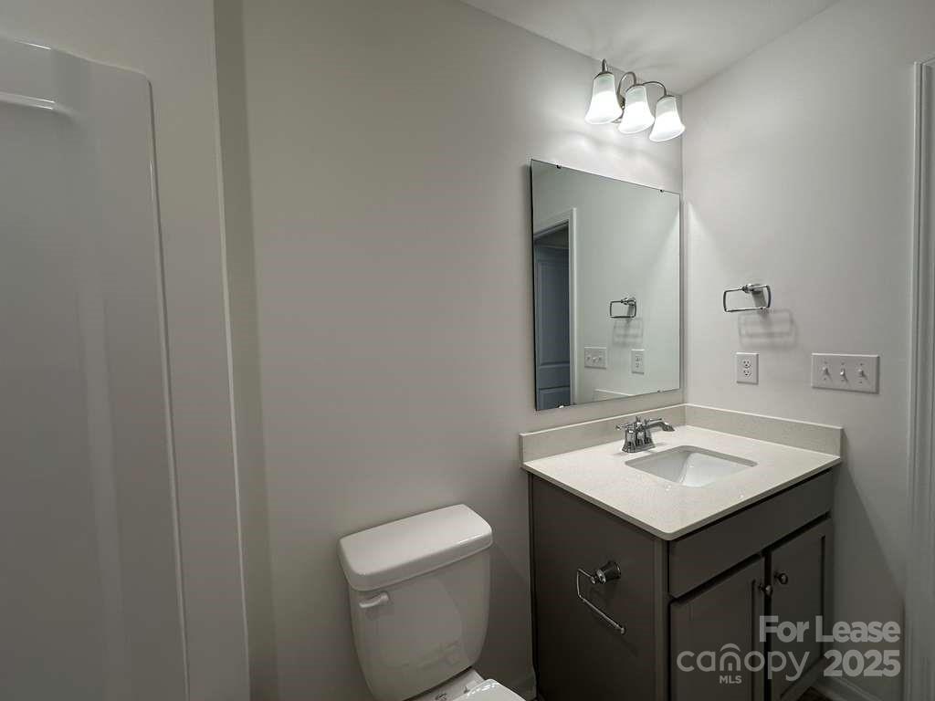 3514 Nimbell Road Monroe, NC 28110 - Photo 7 of 19 a bathroom with a toilet sink and mirror
