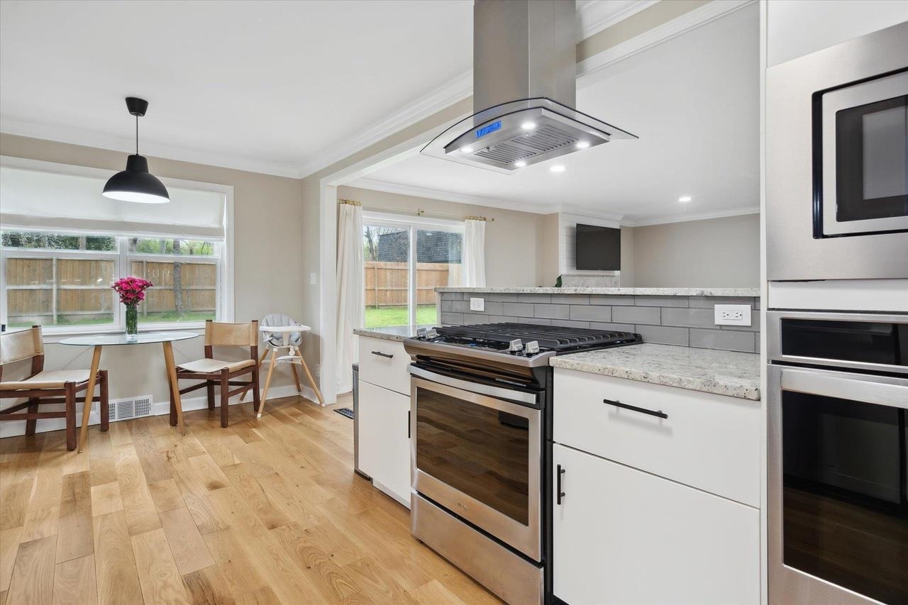 7250 Cedar Road Bartlett, TN 38135 - Photo 11 of 34 a kitchen with stainless steel appliances granite countertop a stove and a wooden floors