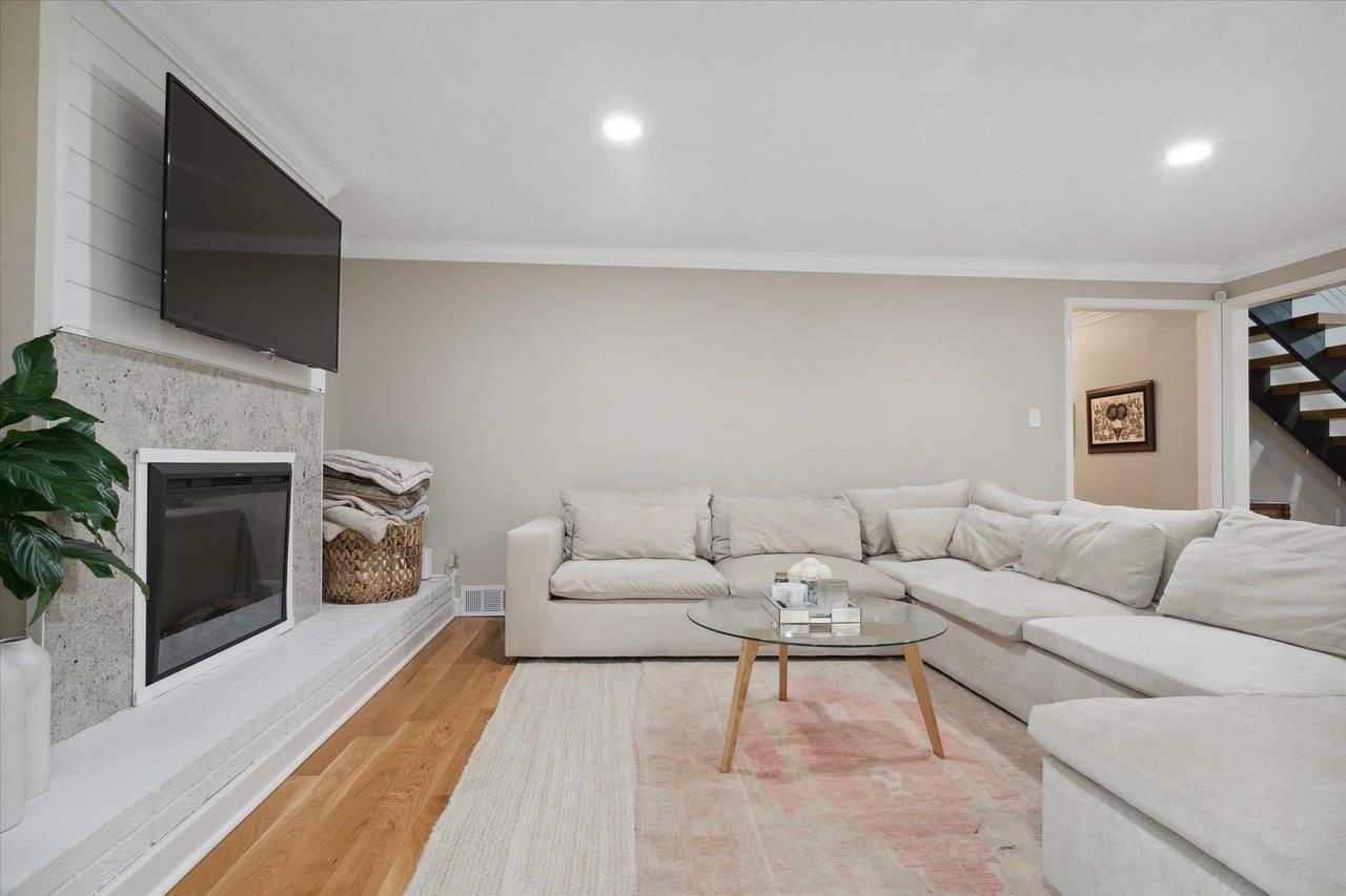 7250 Cedar Road Bartlett, TN 38135 - Photo 14 of 34 a living room with furniture a flat screen tv and a fireplace