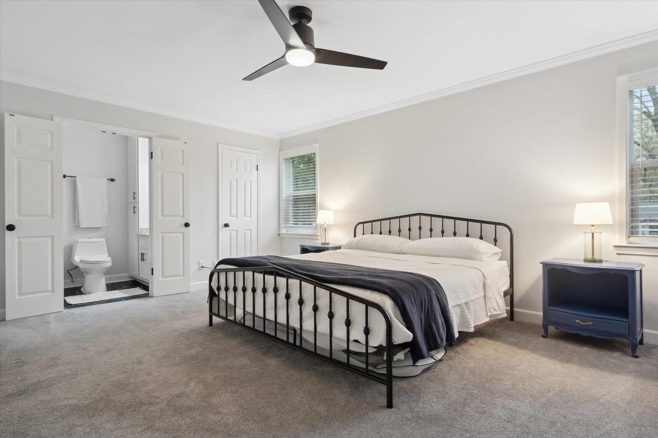 7250 Cedar Road Bartlett, TN 38135 - Photo 17 of 34 a spacious bedroom with a bed and a chandelier