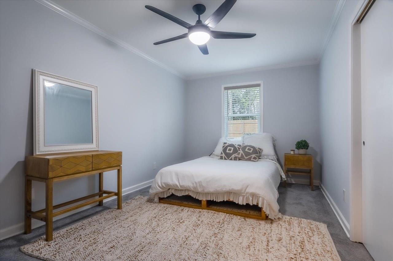 7250 Cedar Road Bartlett, TN 38135 - Photo 20 of 34 a bedroom with a bed and a chandelier