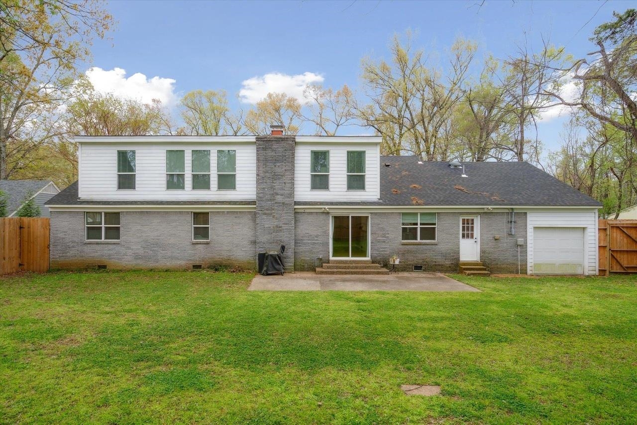 7250 Cedar Road Bartlett, TN 38135 - Photo 32 of 34 a front view of a house with a garden and trees