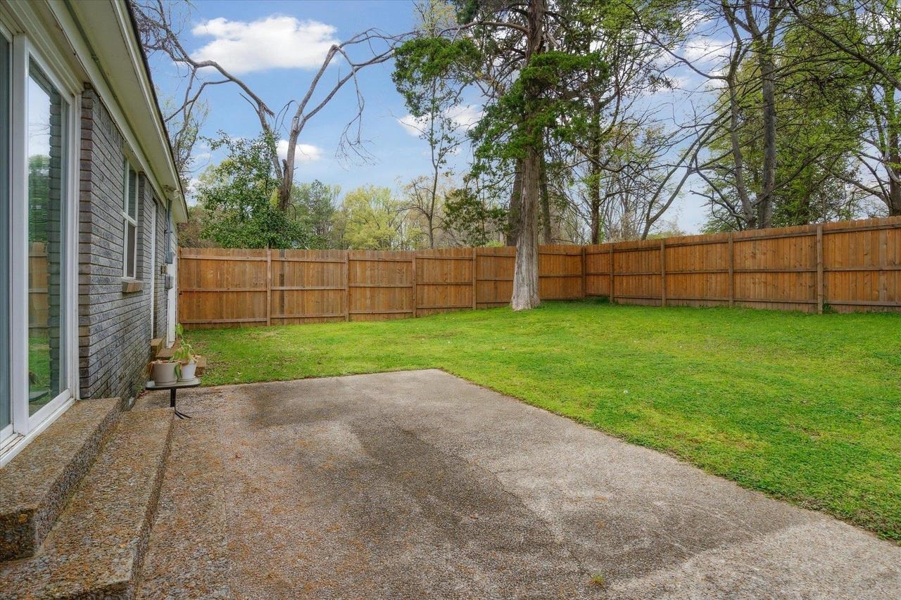 7250 Cedar Road Bartlett, TN 38135 - Photo 34 of 34 a view of a backyard with large trees and wooden fence