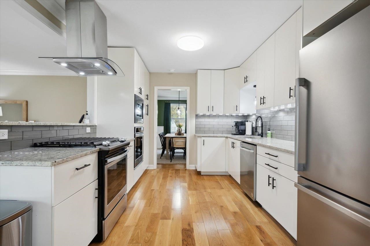7250 Cedar Road Bartlett, TN 38135 - Photo 9 of 34 a kitchen with granite countertop a sink appliances cabinets and a counter top space