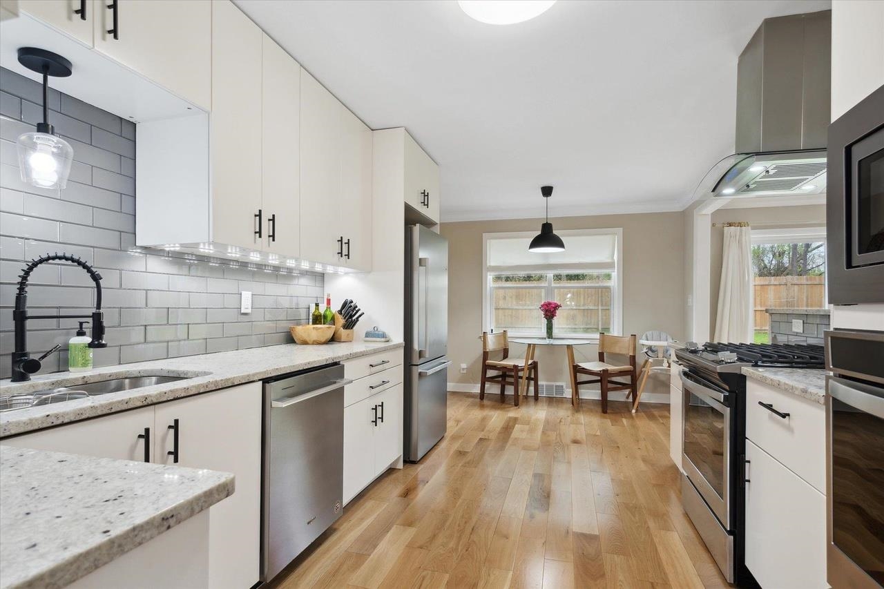 7250 Cedar Road Bartlett, TN 38135 - Photo 10 of 34 a kitchen with stainless steel appliances granite countertop a kitchen island hardwood floor sink stove dining table and chairs