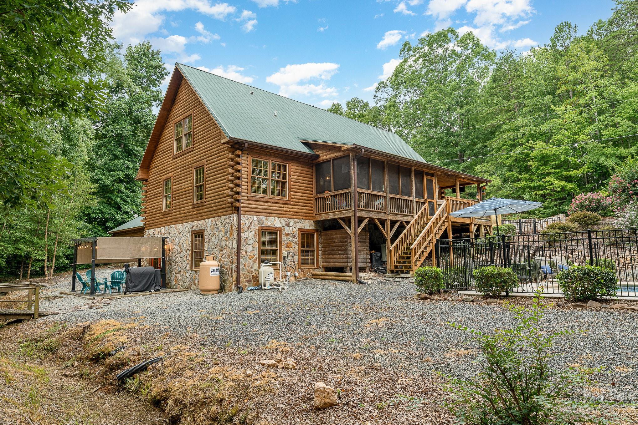 528 Manchester Road Mount Gilead, NC 27306 - Photo 30 of 34 a view of a house next to a yard with plants and large trees