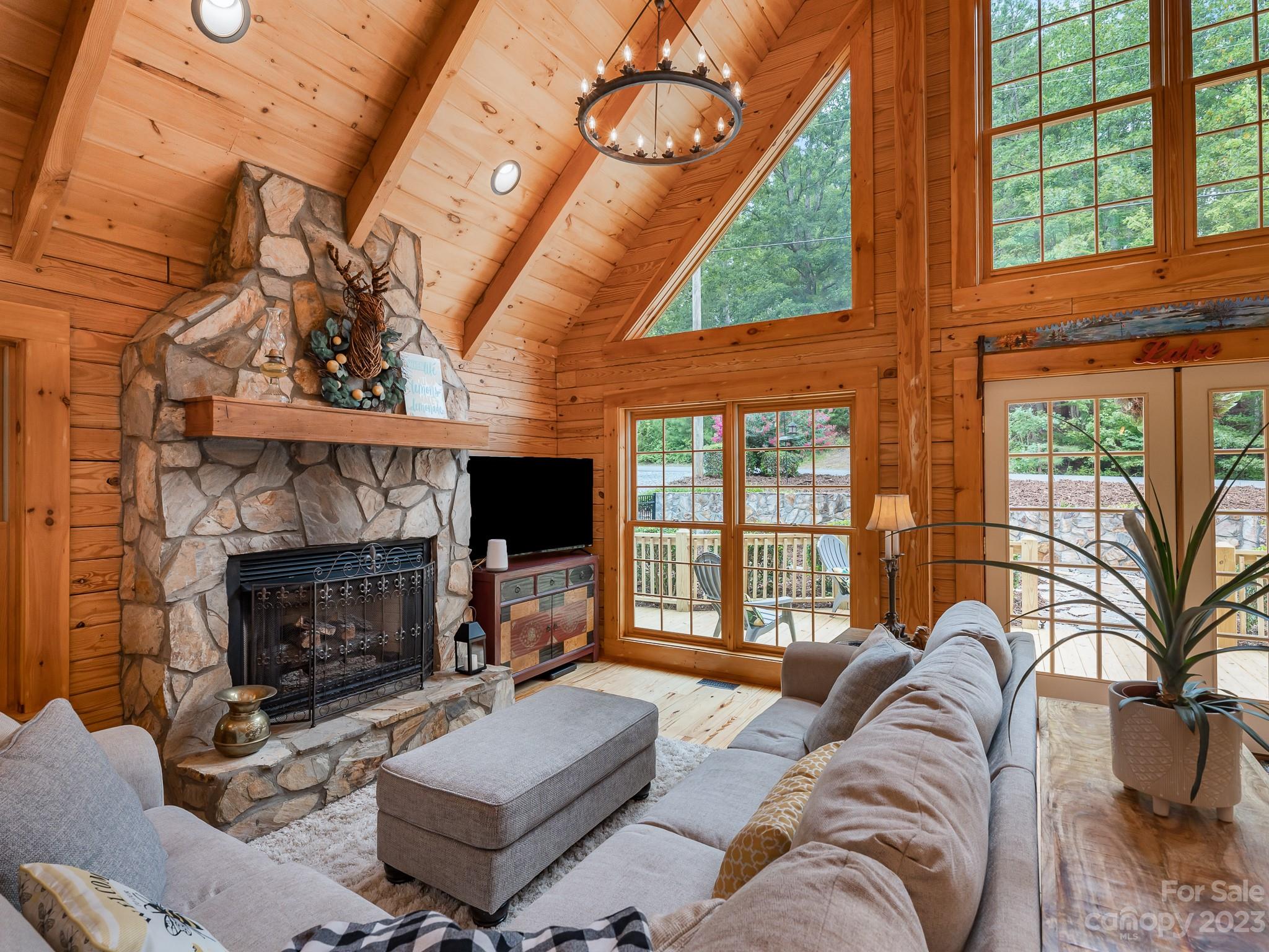 528 Manchester Road Mount Gilead, NC 27306 - Photo 5 of 34 a living room with furniture a fireplace a flat screen tv and a large window