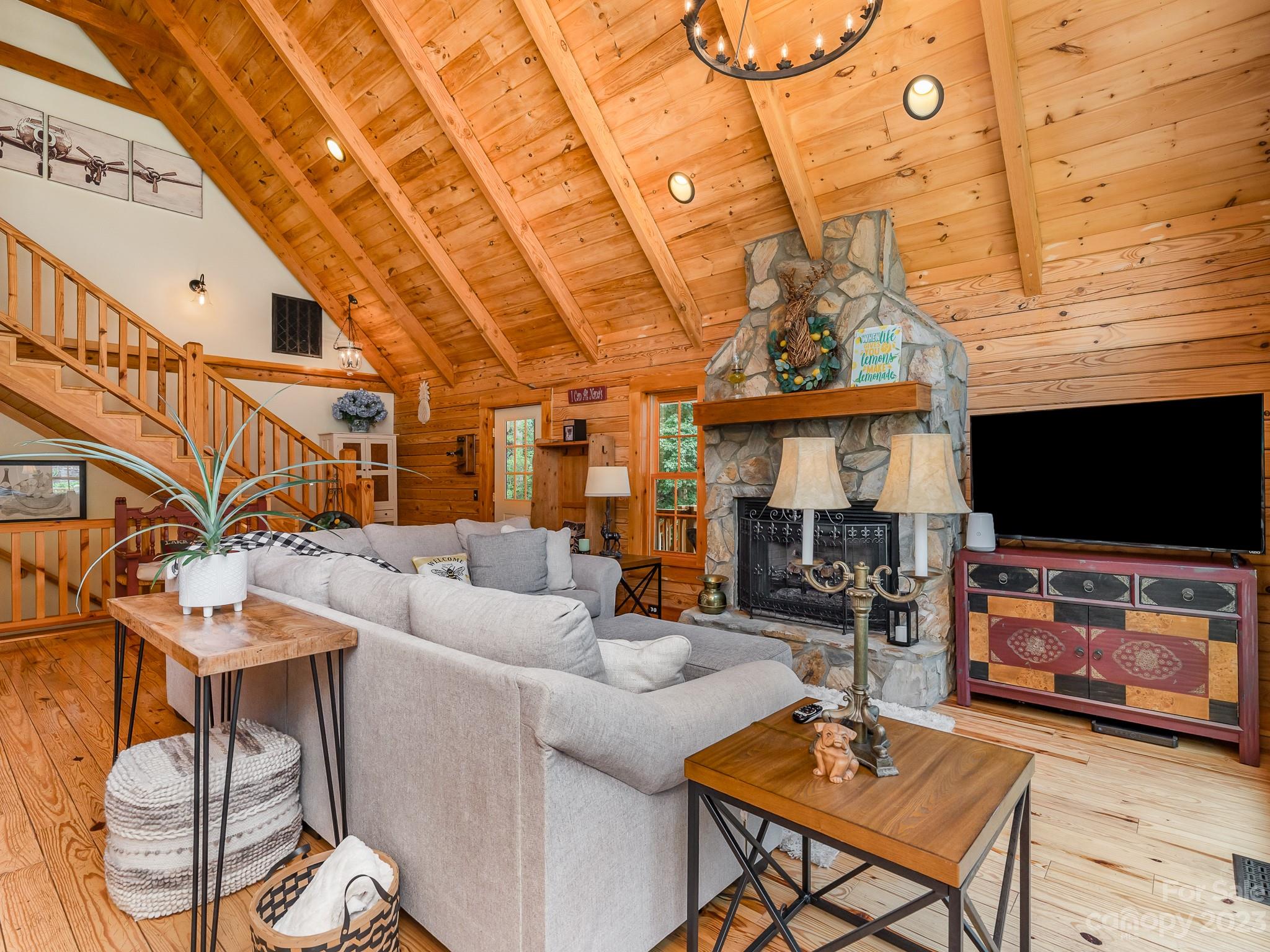 528 Manchester Road Mount Gilead, NC 27306 - Photo 7 of 34 a living room with furniture a flat screen tv and a floor to ceiling window