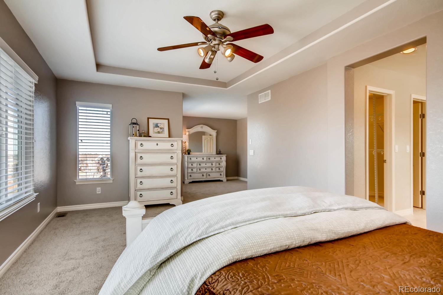 10951 Bluegate Way Highlands Ranch, CO 80130 - Photo 13 of 27 a bedroom with a bed dresser and a window