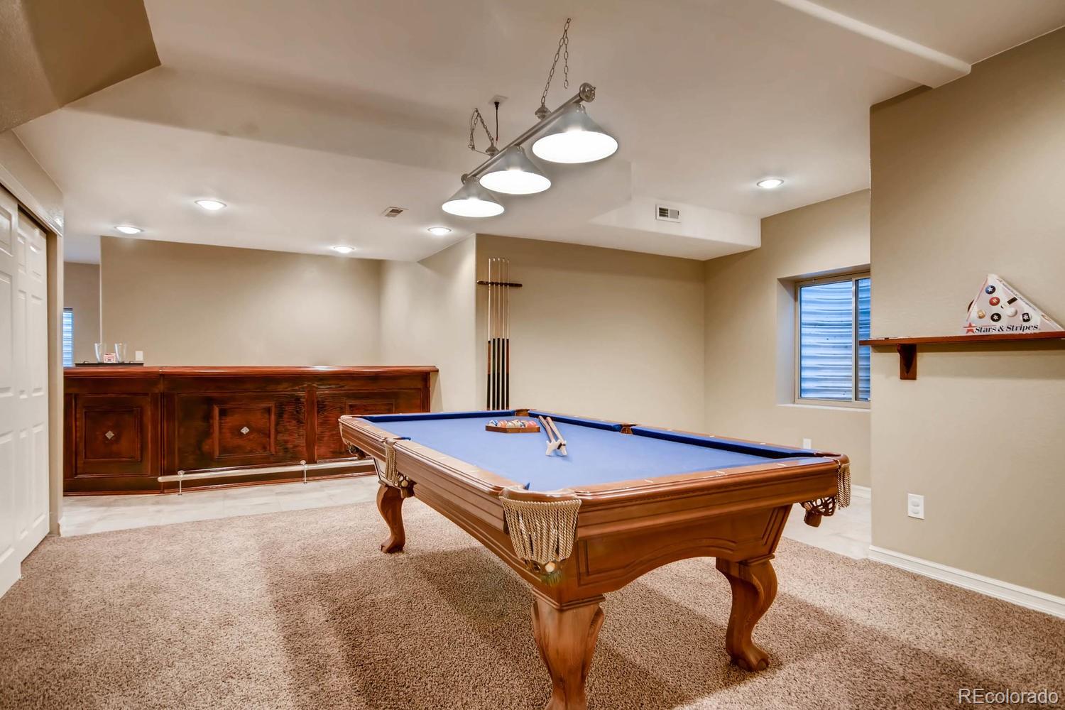 10951 Bluegate Way Highlands Ranch, CO 80130 - Photo 22 of 27 a room with pool table and a chandelier