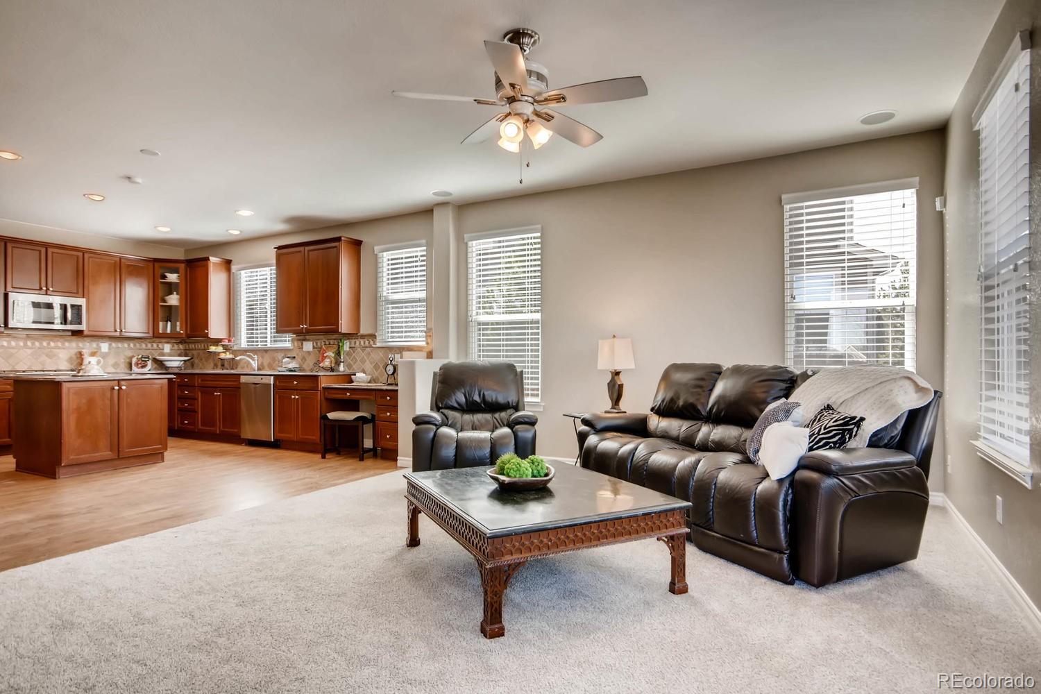 10951 Bluegate Way Highlands Ranch, CO 80130 - Photo 3 of 27 a living room with furniture kitchen view and a large window
