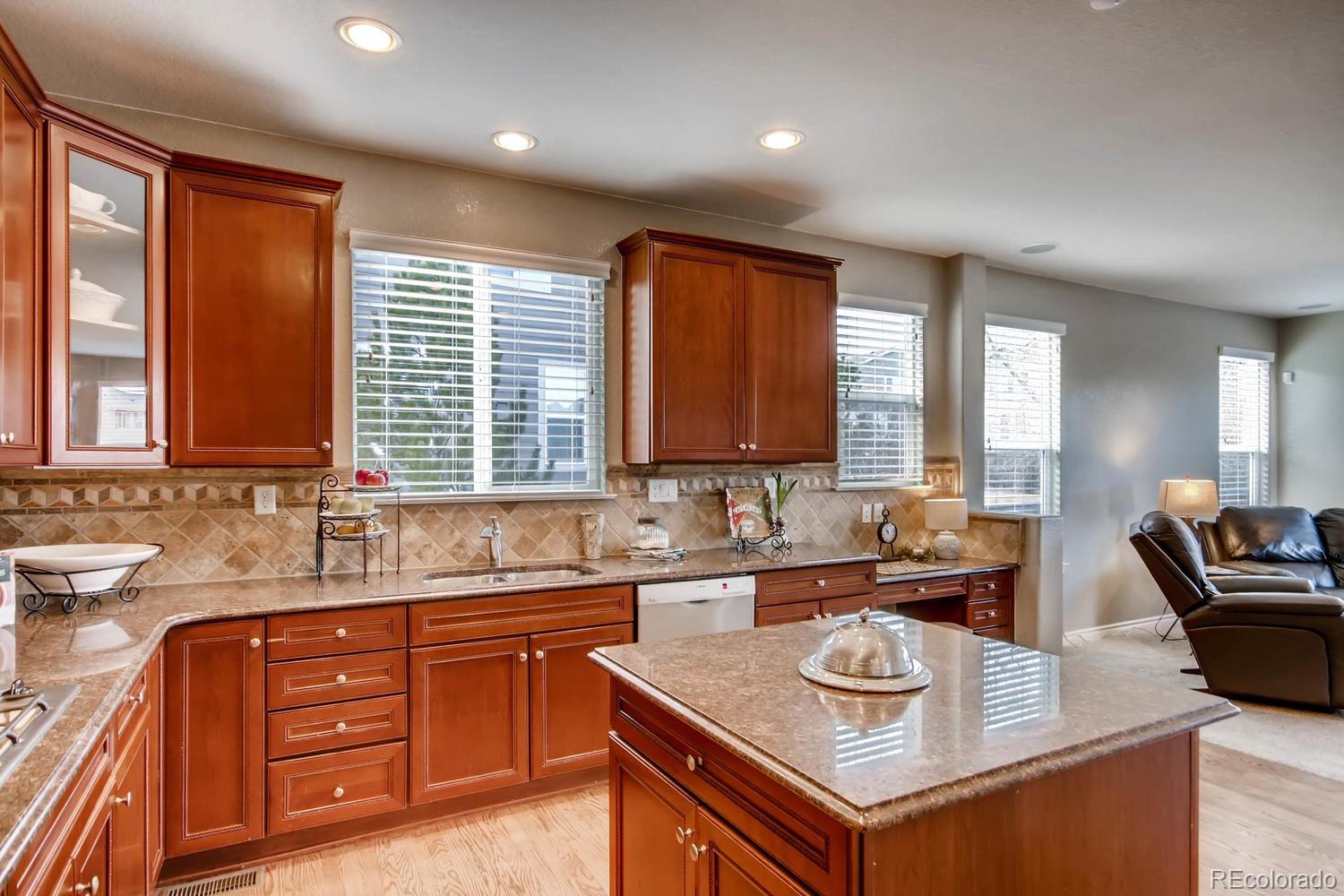 10951 Bluegate Way Highlands Ranch, CO 80130 - Photo 8 of 27 a kitchen with a sink stove and cabinets