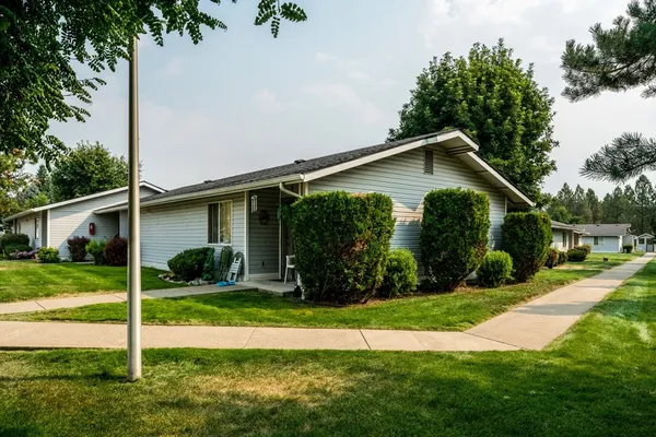 a front view of house with yard and green space