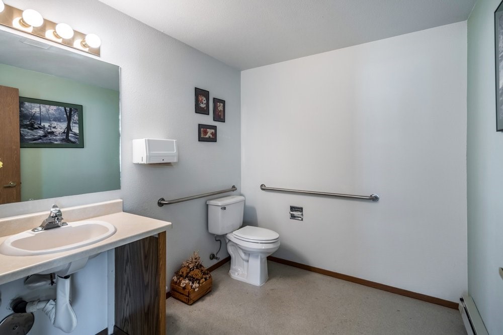 7032 Heritage Street Rathdrum, ID 83858 - Photo 10 of 10 a bathroom with a sink mirror and toilet