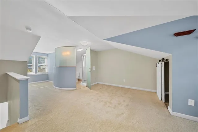a view of empty room with a fireplace