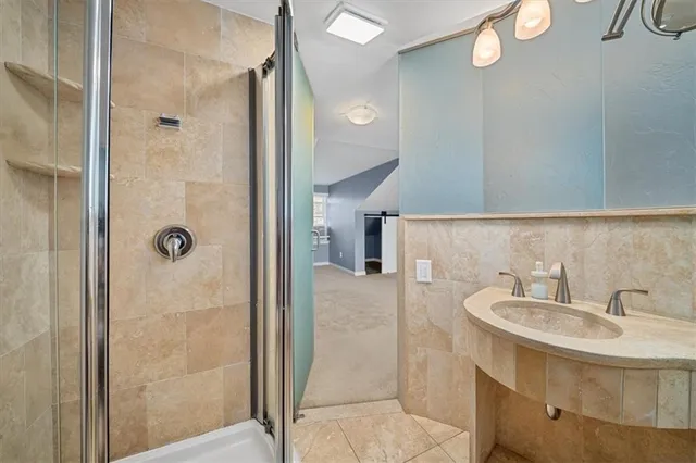a bathroom with a sink a mirror and a shower