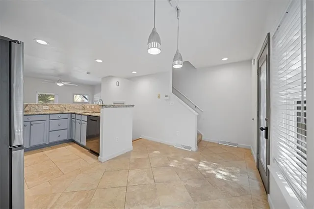 a view of a kitchen with a sink and a refrigerator