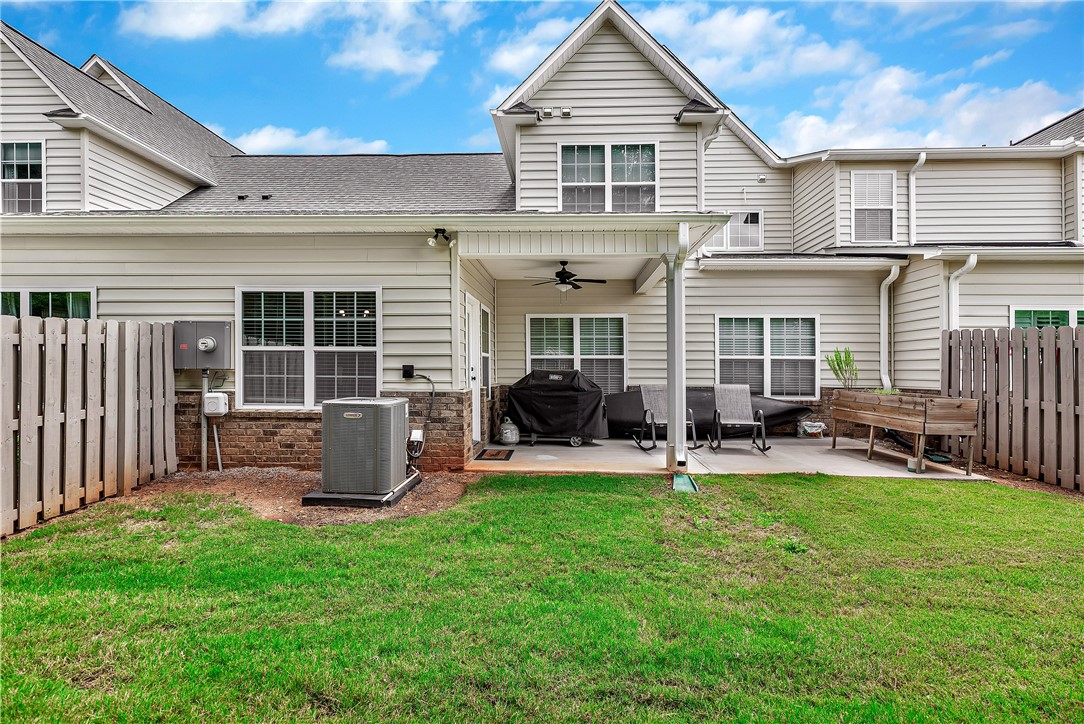 111 Coosa Lane Anderson, SC 29621 - Photo 17 of 36 A well-maintained lawn provides a pleasant backdrop to the private patio space, perfect for outdoor relaxation.