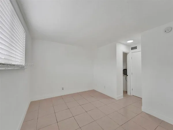 a view of an empty room and window